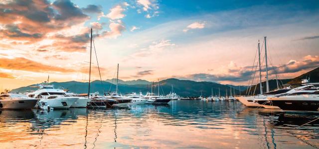 Luxury Yachts and Motor Boats Docked in Sea at Sunset